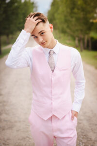 high school graduate posing in pink suit calgary grad photoshoot