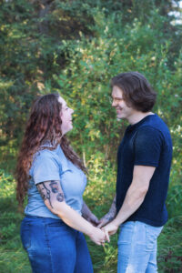 young couple in love posing for photograph in Griffith Woods Calgary family photographer