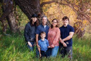 family of five posing for photos in fish creek park calgary alberta