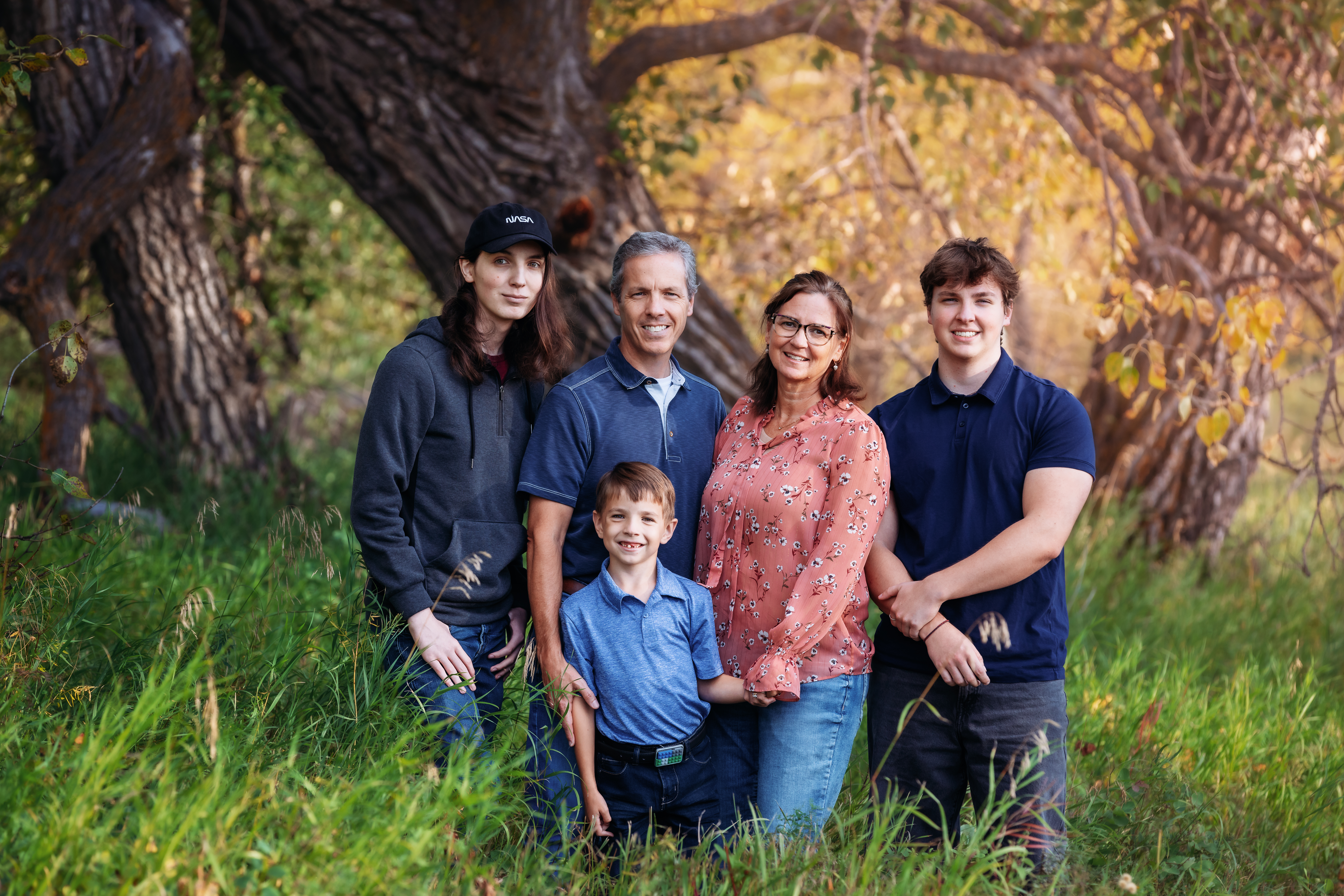 family of five posing for photos in fish creek park calgary alberta