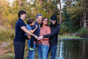 family of family smiling and having fun at fish creek park calgary alberta