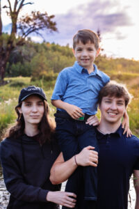 three brothers posing for family photos in fish creek park calgary alberta