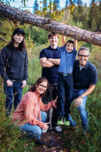family of family smiling at fish creek park calgary alberta
