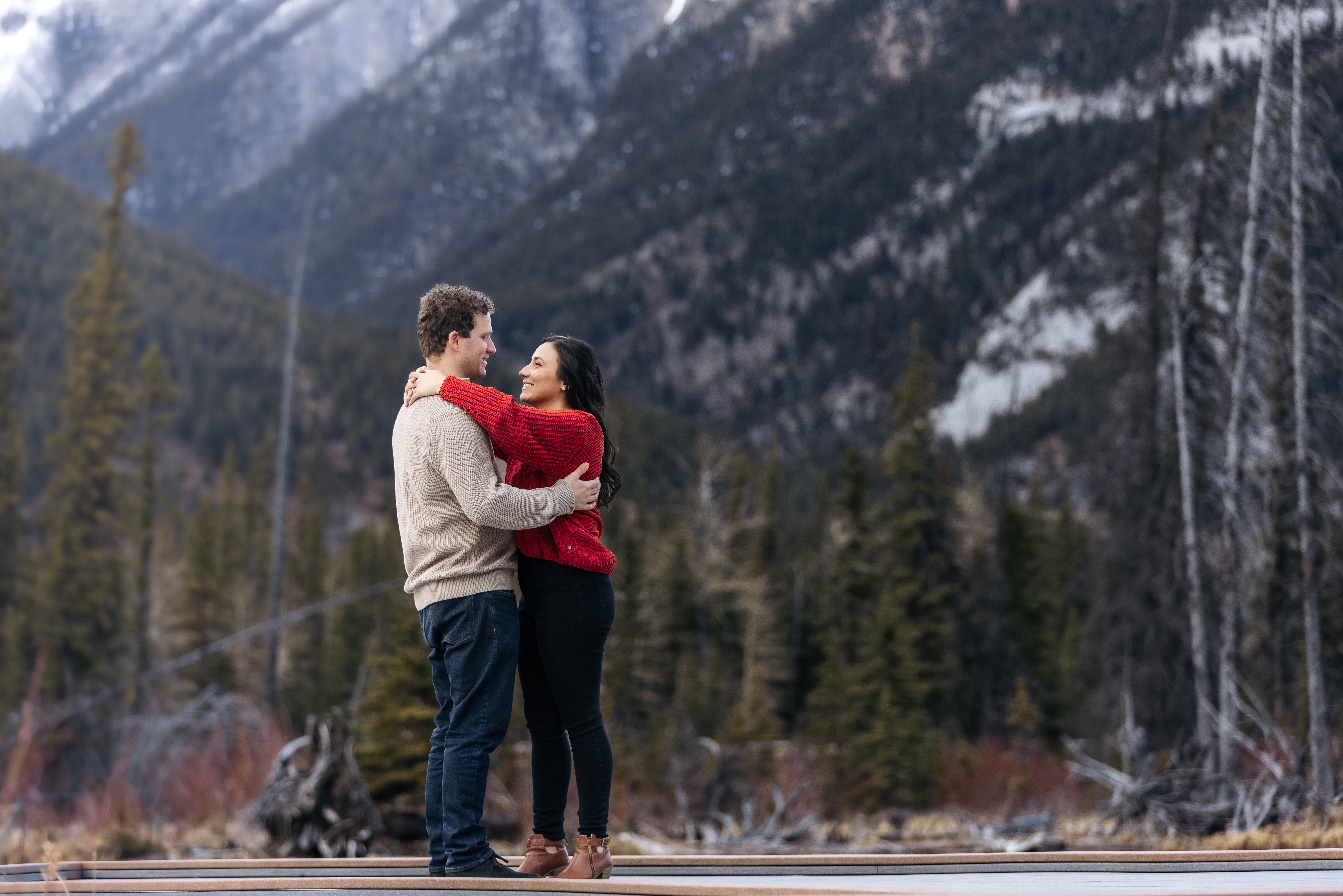 couple dancing on boat dock in Kananaskis during a winter engagement photo shoot
