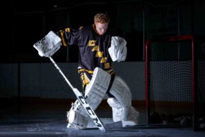 calgary hockey goalie in the crease blocking the puck
