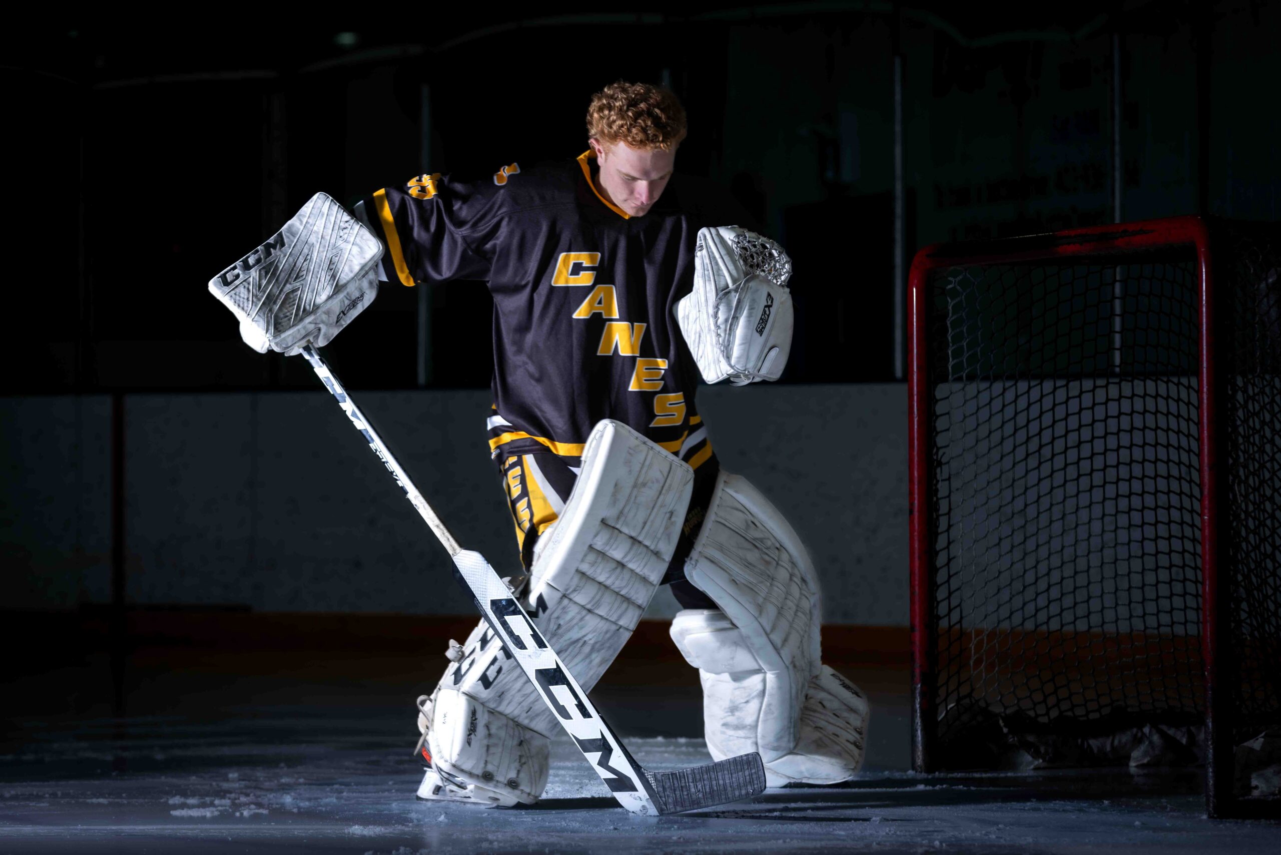 calgary hockey goalie in the crease blocking the puck