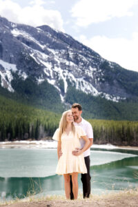 Engaged couple snuggling together in Kananaskis Country