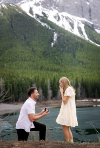 Man proposing beside a mountain lake in Kananaskis Country near Calgary, Alberta